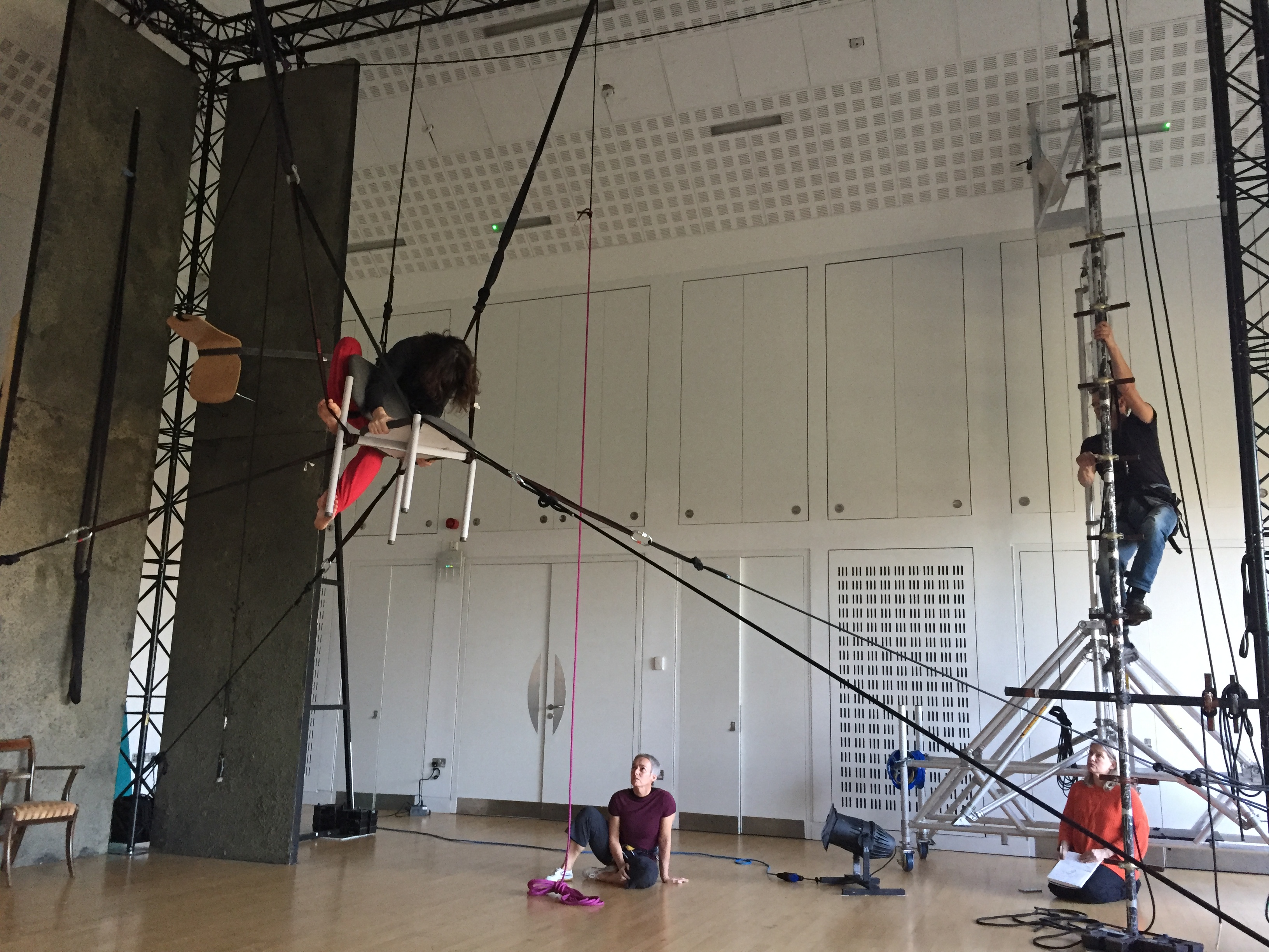 Aerial performer in suspended chair rigged from multiple points in Creation Space